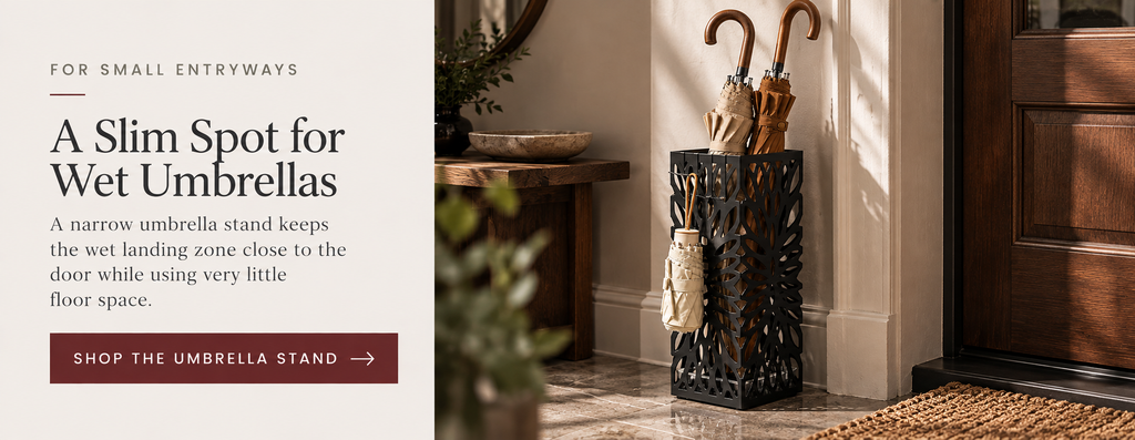 Editorial product card featuring a slim black umbrella stand for storing umbrellas beside the front door in a small entryway.
