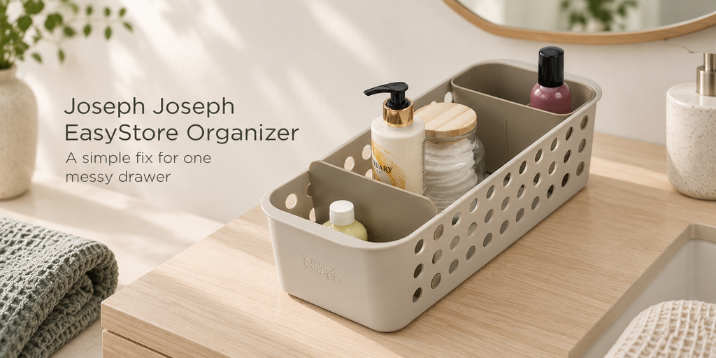 Joseph Joseph EasyStore bathroom organizer holding everyday toiletries on a light wood vanity.